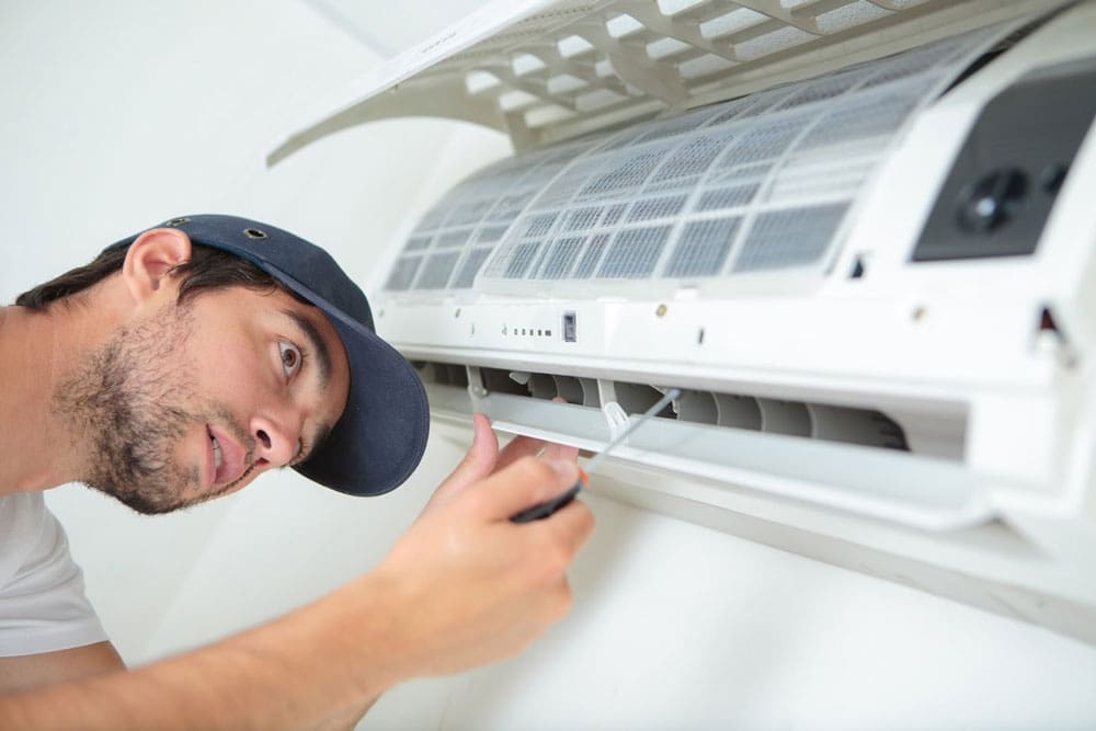 man fixing an air conditioner