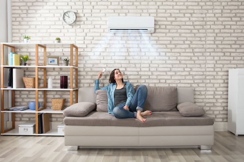 woman enjoying air conditioner