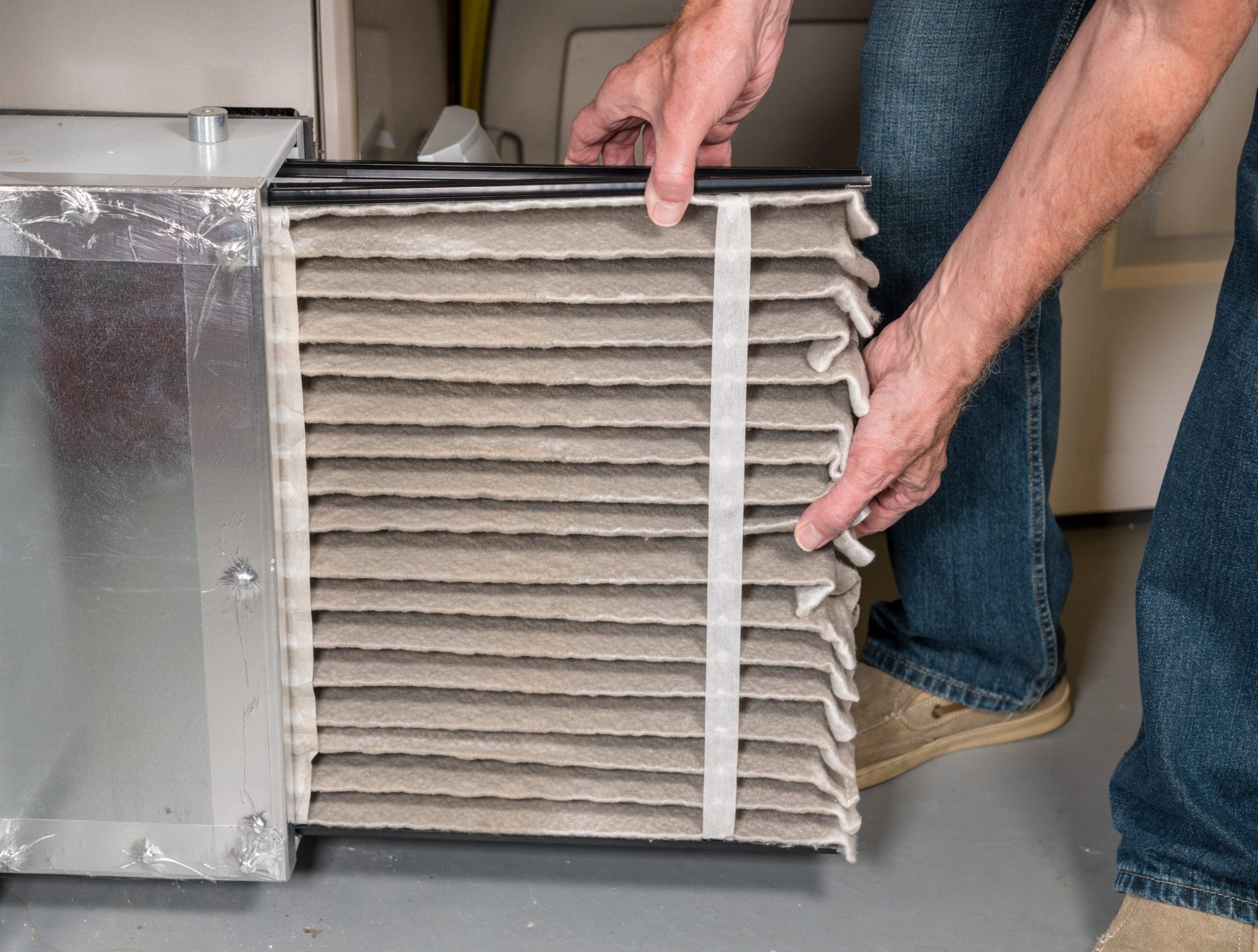 person changing furnace air filter