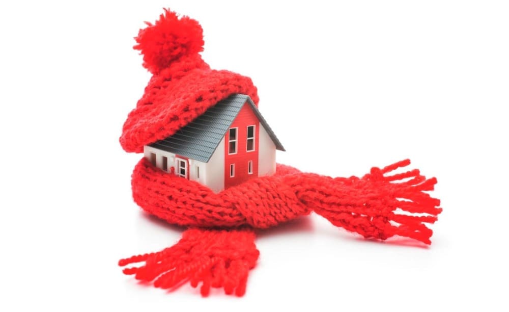 a toy house wearing a scarf and hat